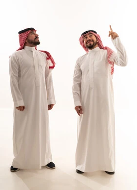 Saudi Men in Traditional Thobes Pointing Upward