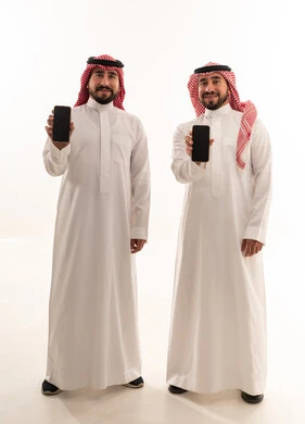 Saudi Men in Traditional Thobes Holding Smartphones