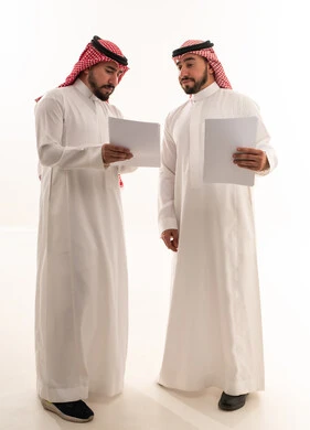 Saudi Businessmen Reviewing Documents in Studio