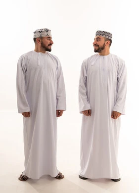 Omani Men in Traditional Dishdasha and Kumma