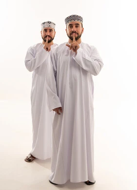 Omani Men in Traditional Dress with Silence Gesture
