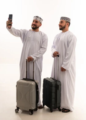 Omani Men with Travel Suitcases and Smartphone