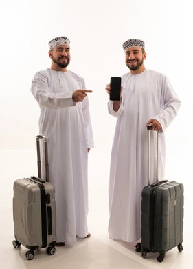 Omani Men Traveling with Suitcases and Smartphone