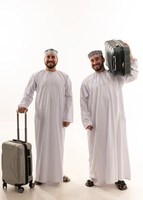Omani Men in Traditional Dress with Travel Suitcases