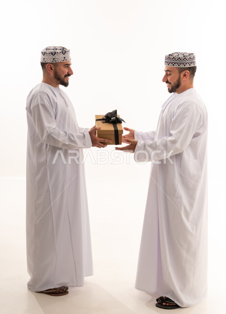 Omani Men Exchanging Gift in Traditional Attire