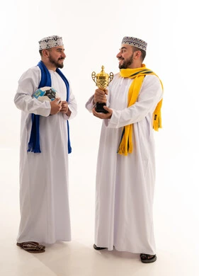 Omani Men in Traditional Dress with Football Trophy
