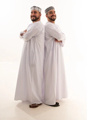 Omani Men in Traditional Dishdasha and Kumma