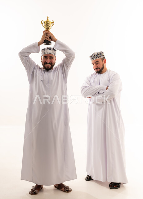 Omani Men Celebrating Victory with Gold Trophy