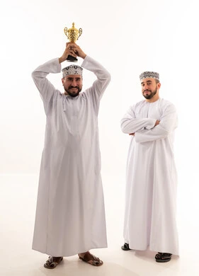 Omani Men Celebrating Victory with Gold Trophy