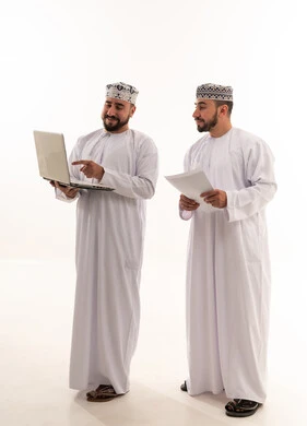 Omani Men Using Laptop in Traditional Clothing