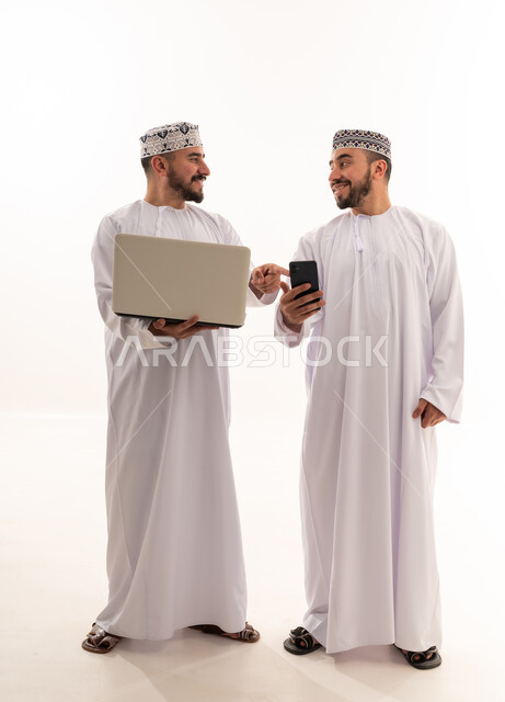 Omani Men Using Laptop and Smartphone on White Background