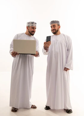 Omani Men Using Laptop and Smartphone on White Background