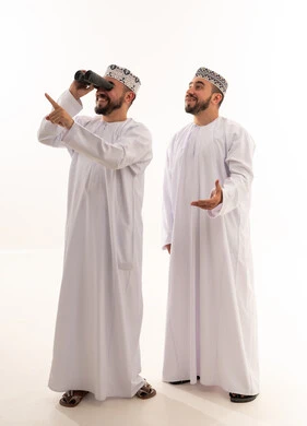 Omani Men in Traditional Dress Using Binoculars