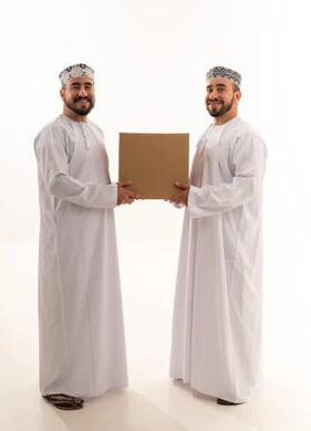 Omani Men Holding Cardboard Box on White Background