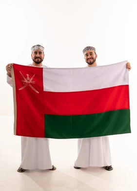 Two Omani Men Holding National Flag of Oman