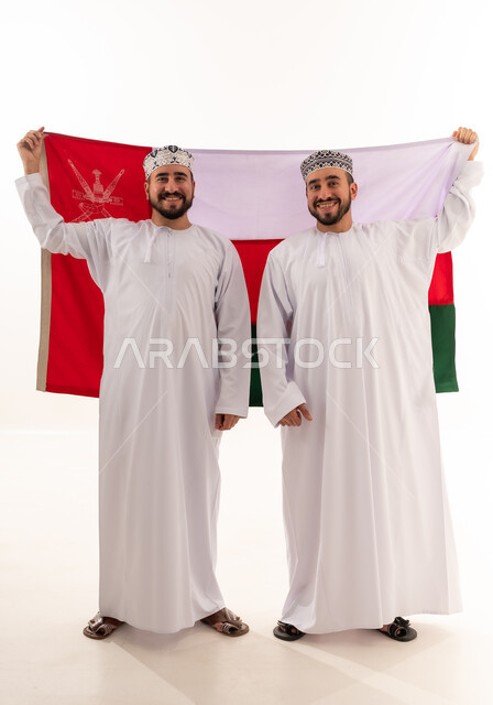 Omani Men in Traditional Dress Holding Oman Flag