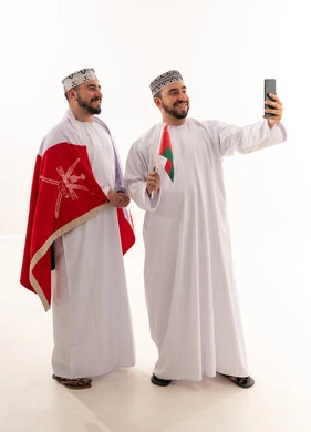 Omani Men in Traditional Dress Taking Selfie with Flag