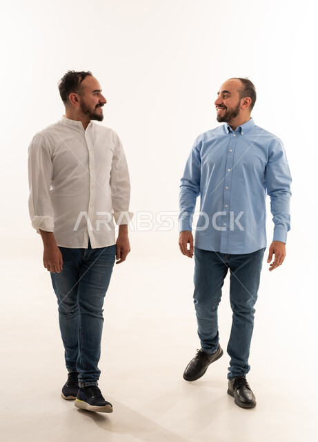 Saudi Men Walking Together in Studio on White Background