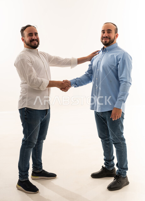 Two Saudi Men Shaking Hands on White Background