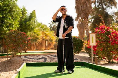 رجل سعودي يلعب الميني غولف في الخارج