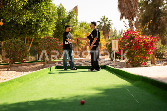 Saudi Men Handshake at Mini Golf Course