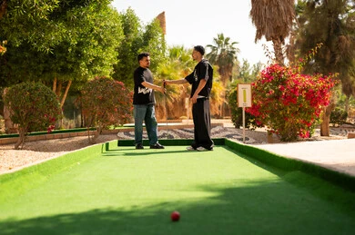 Saudi Men Handshake at Mini Golf Course