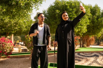 Arab Couple Taking Selfie on Golf Course