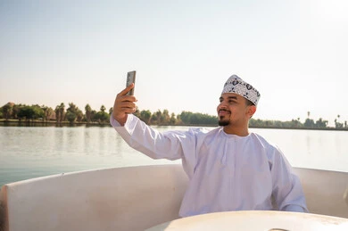 Omani Man on Boat Taking Selfie Daytime
