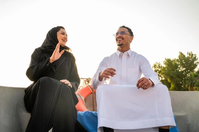 Saudi Couple Smiling on Boat in Traditional Clothing