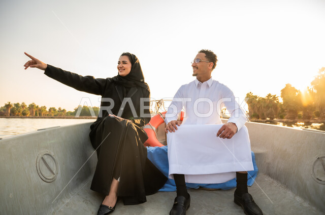 Saudi Couple on River Boat at Sunset