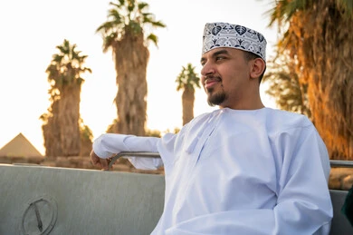 رجل عماني عند أهرامات الجيزة وقت الغروب