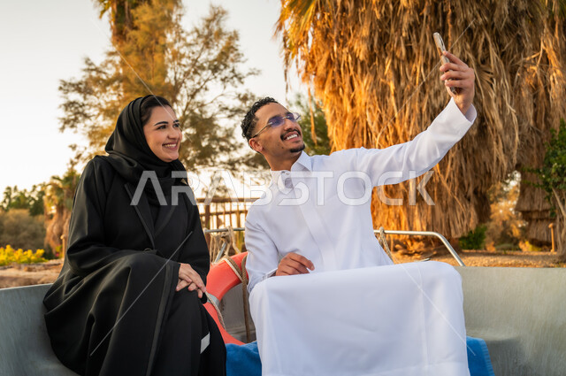 Saudi Couple Taking Selfie on Boat at Sunset