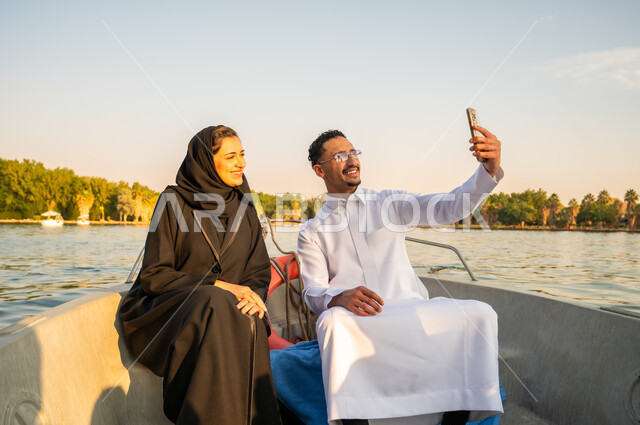 Saudi Couple Taking Selfie on Boat at Sunset Leisure