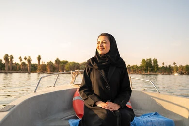 Saudi Woman in Abaya on Boat at Sunset