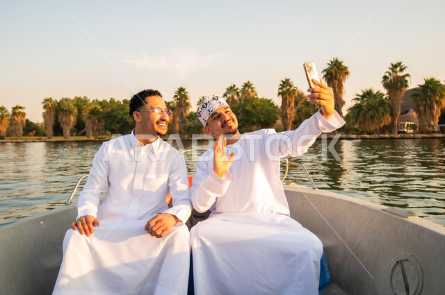 Omani Men in Traditional Dress Taking Selfie on Boat
