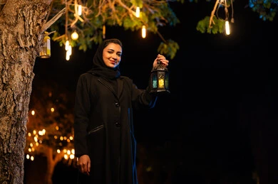 Saudi Woman Holding Traditional Ramadan Lantern at Night