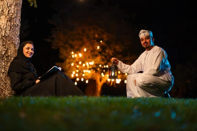 Omani Couple with Lantern and Book at Night