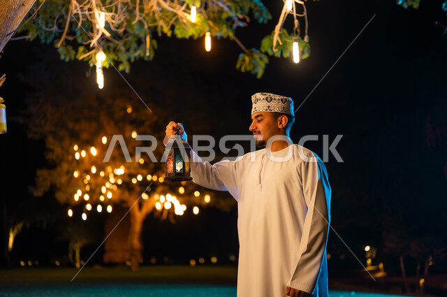 Omani Man with Traditional Lantern at Night