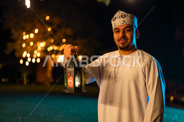 Omani Man with Traditional Lantern at Night