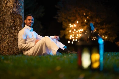 Saudi Man in White Thobe with Ramadan Lantern at Night