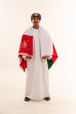 Omani Man in Traditional Dress with National Flag