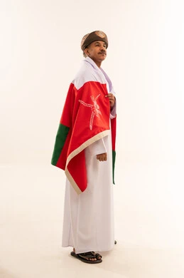 Omani Man Wearing Traditional Dress and National Flag