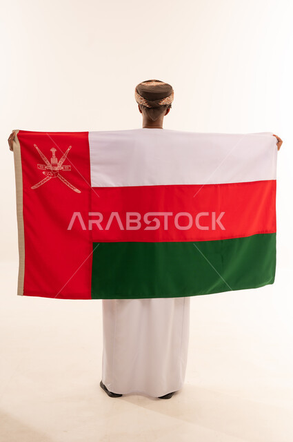 Omani Man Holding Oman National Flag Back View