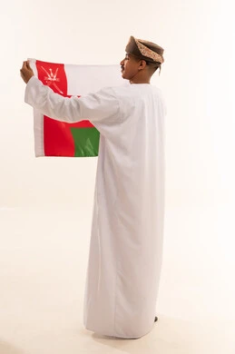 Omani Man Holding National Oman Flag in Studio