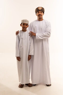 Omani Man and Boy in Traditional Dishdasha Dress