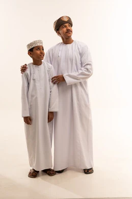 رجل وطفل عماني بالزي الوطني التقليدي
