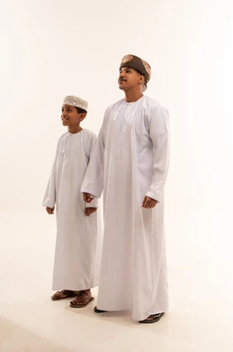 Omani Man and Boy in Traditional Dishdasha Dress