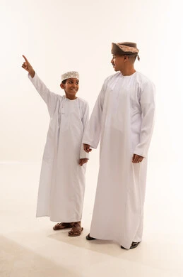Omani Man and Boy in Traditional Dress on White Background