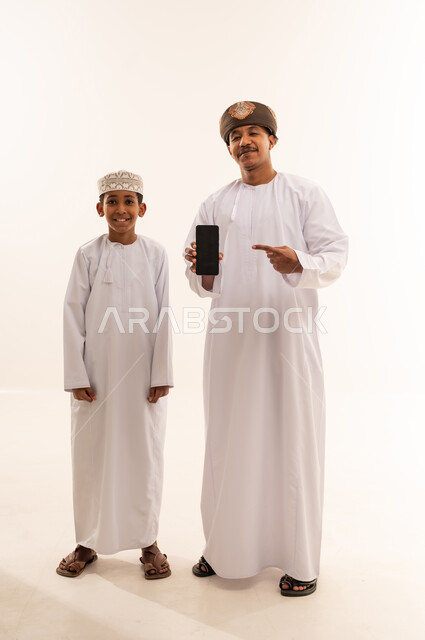 Omani Man and Boy with Smartphone in Studio