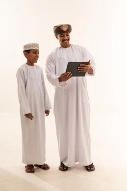 Omani Man and Boy Using Tablet in Studio